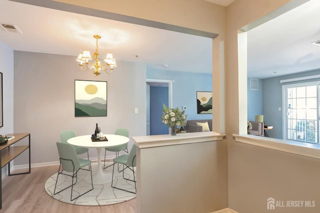 914 Cedar Ct, New Brunswick, NJ 08901 - dining area featuring wood finished floors and a chandelier