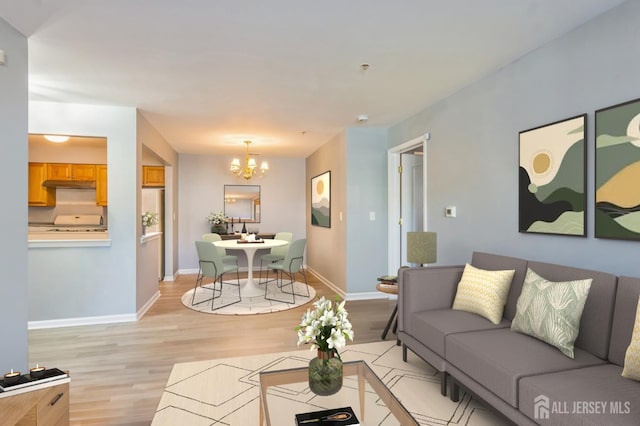 914 Cedar Ct, New Brunswick, NJ 08901 - living room with light wood-type flooring, a chandelier, and baseboards