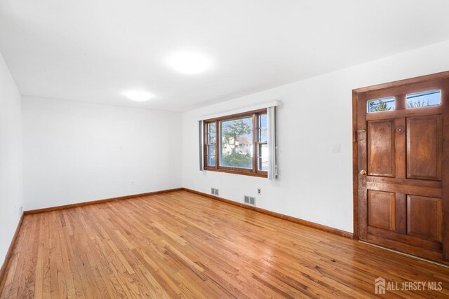 unfurnished room featuring light hardwood / wood-style floors