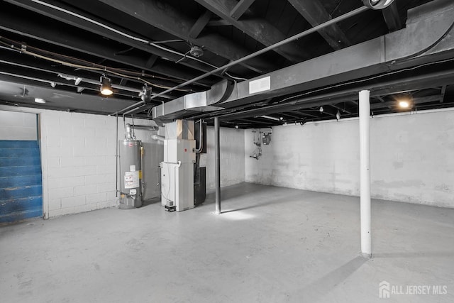 unfinished below grade area featuring water heater, visible vents, and heating unit