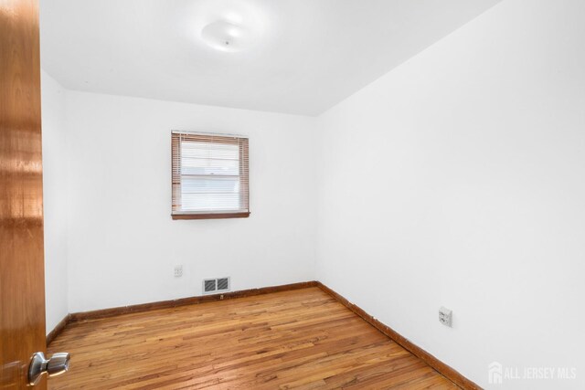 unfurnished room with light hardwood / wood-style flooring