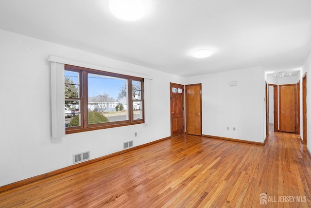 empty room with light hardwood / wood-style floors