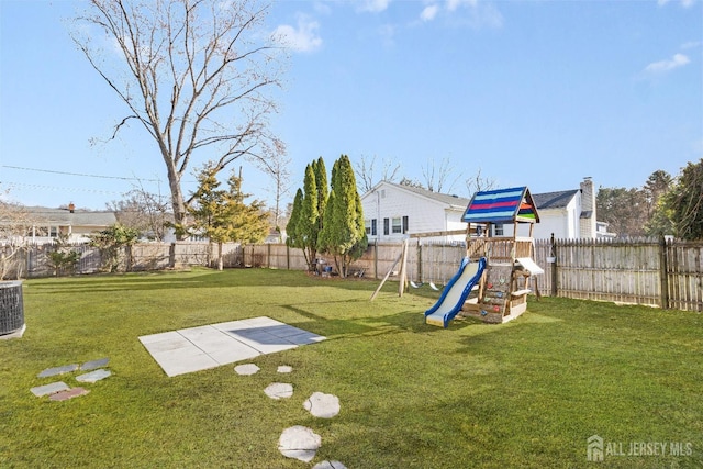 view of yard featuring a fenced backyard and a playground