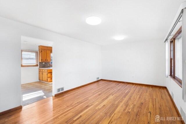 spare room featuring light hardwood / wood-style flooring