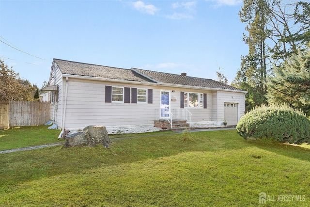 single story home featuring an attached garage, fence, and a front yard