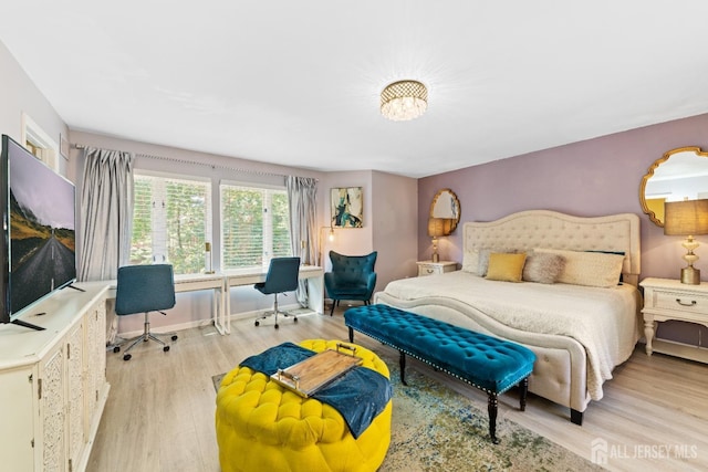 bedroom featuring baseboards and light wood-style flooring