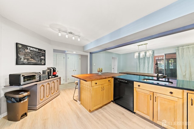 kitchen with light wood-style flooring, light brown cabinetry, a sink, black dishwasher, and hanging light fixtures