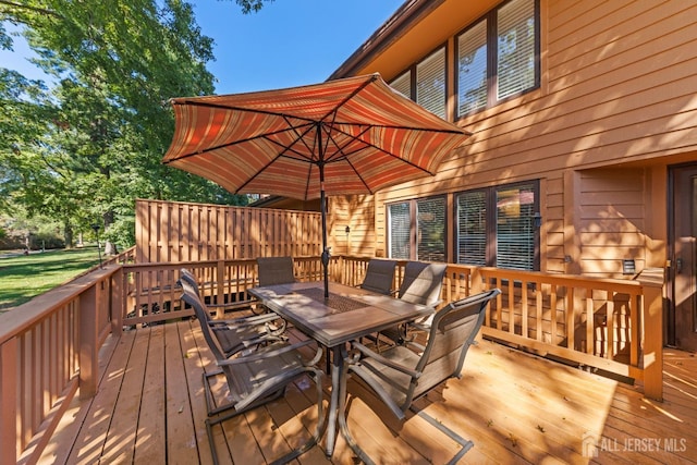 wooden deck featuring outdoor dining area