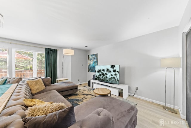 living room with light wood-type flooring and baseboards