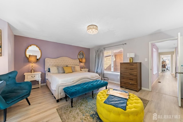 bedroom with wood finished floors and baseboards