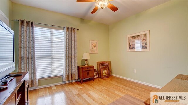 sitting room with light hardwood / wood-style flooring, plenty of natural light, and ceiling fan