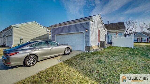 view of side of home with a garage, a lawn, and central air condition unit