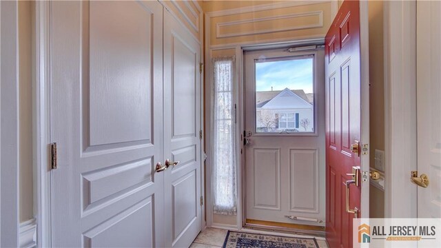 doorway to outside with light tile patterned floors