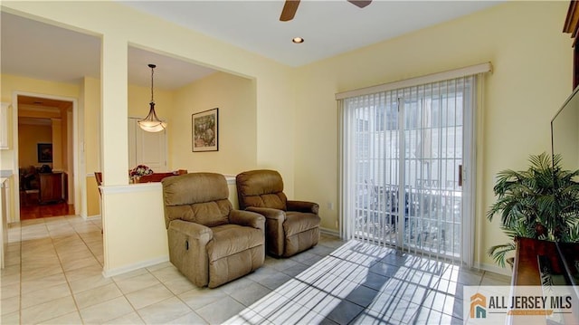 living room featuring ceiling fan and light tile patterned floors