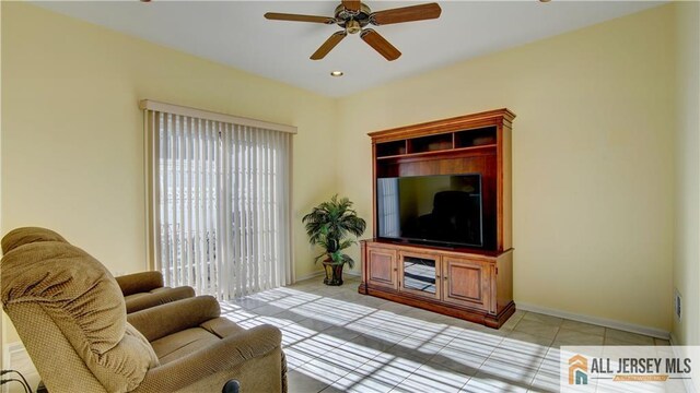 tiled living room featuring ceiling fan