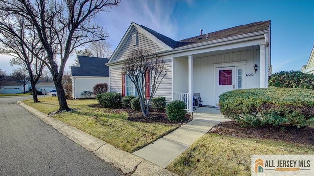 ranch-style house with a front lawn and covered porch