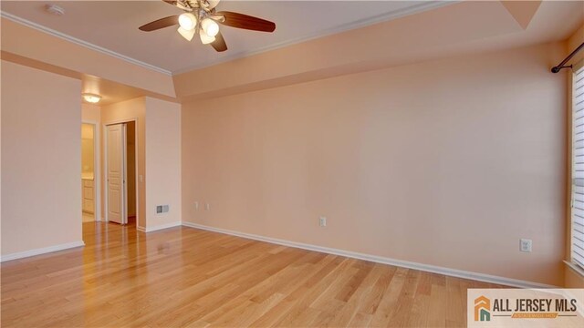 empty room with crown molding, light hardwood / wood-style flooring, and ceiling fan