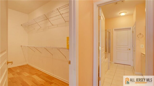 walk in closet featuring hardwood / wood-style floors