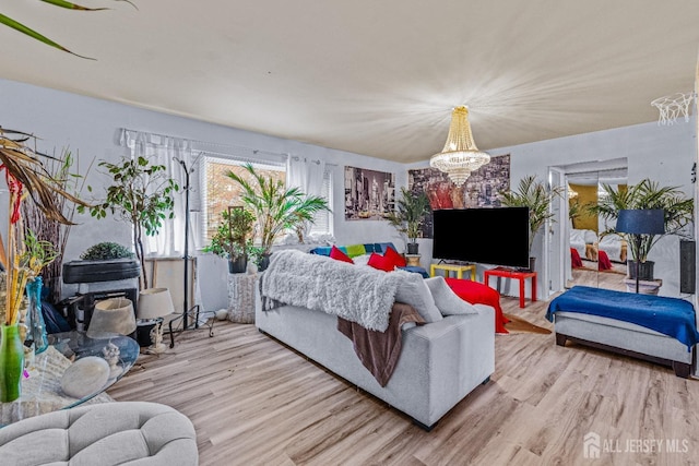 living area featuring wood finished floors and a notable chandelier