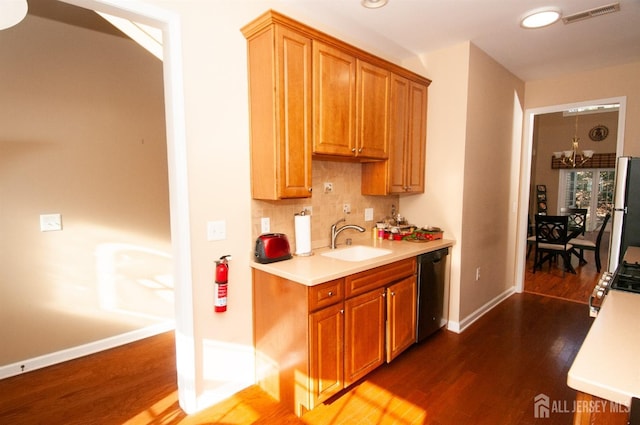 kitchen with black dishwasher, sink, dark wood-type flooring, and decorative backsplash