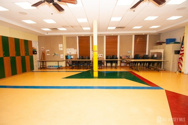 interior space featuring ceiling fan, a paneled ceiling, and basketball hoop