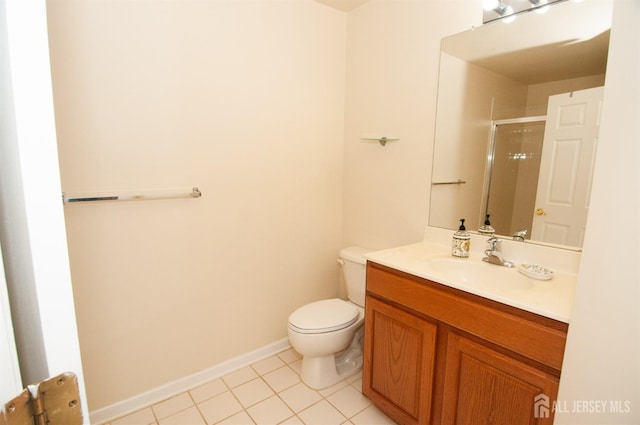 bathroom with a shower with door, vanity, tile patterned flooring, and toilet