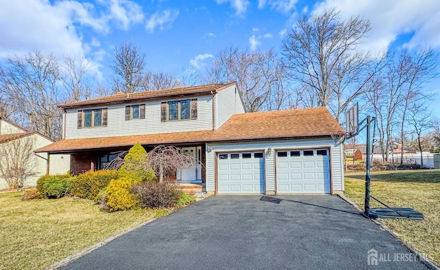 traditional home featuring a front yard, a garage, and aphalt driveway