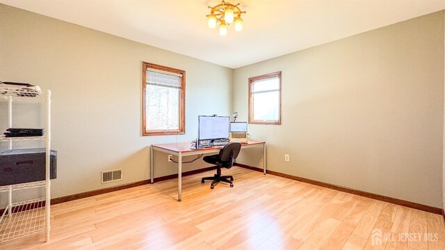 office with wood finished floors, baseboards, a chandelier, and visible vents