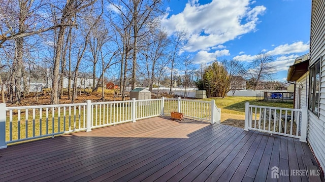 deck with an outdoor structure, fence, a storage unit, and a yard