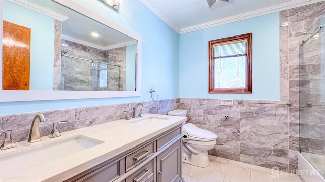 bathroom featuring crown molding, toilet, tiled shower, visible vents, and tile walls
