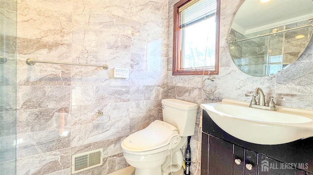 full bathroom with toilet, walk in shower, vanity, and visible vents