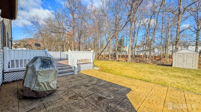 view of yard featuring a patio, a shed, an outdoor structure, and a wooden deck