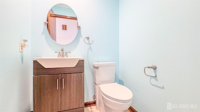 bathroom with toilet and vanity