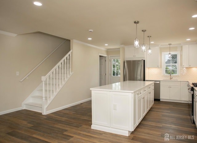 15 Bradley Dr, Edison, NJ 08817 - kitchen with stainless steel appliances, recessed lighting, backsplash, ornamental molding, and a center island