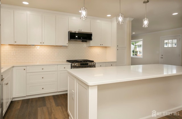 15 Bradley Dr, Edison, NJ 08817 - kitchen with appliances with stainless steel finishes, dark wood-type flooring, ornamental molding, white cabinetry, and light countertops