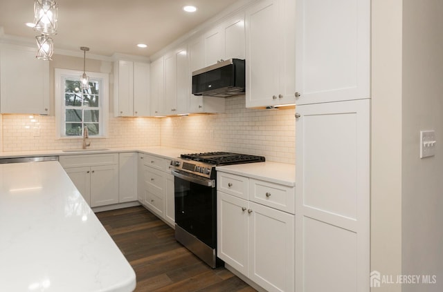15 Bradley Dr, Edison, NJ 08817 - kitchen with appliances with stainless steel finishes, light countertops, white cabinets, dark wood finished floors, and ornamental molding