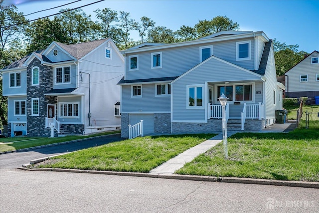 5 Alvin Ct, Menlo Park Terrace, NJ 08840 - view of front of home featuring a garage, a front yard, a porch, stone siding, and driveway