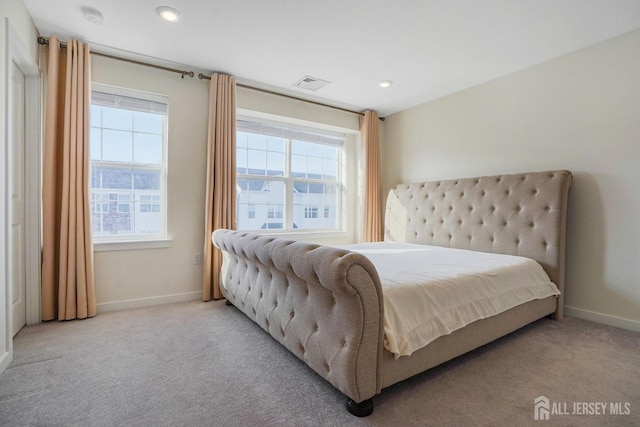 bedroom featuring light carpet, recessed lighting, visible vents, and baseboards