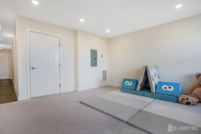 recreation room featuring carpet, recessed lighting, visible vents, electric panel, and baseboards