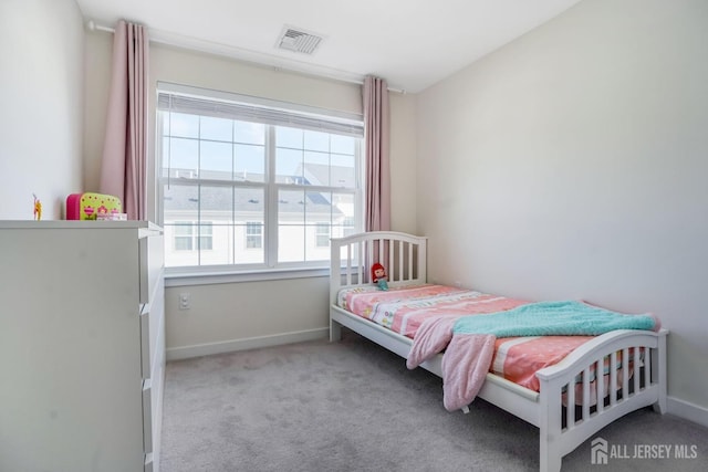 bedroom with light colored carpet, visible vents, and baseboards