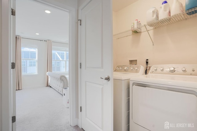 clothes washing area with light carpet, laundry area, washer and clothes dryer, and recessed lighting