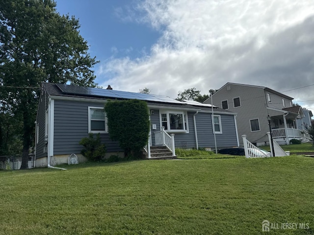 38 Victory Pl E, Brunswick, NJ 08816 - view of front of house featuring solar panels and a front lawn