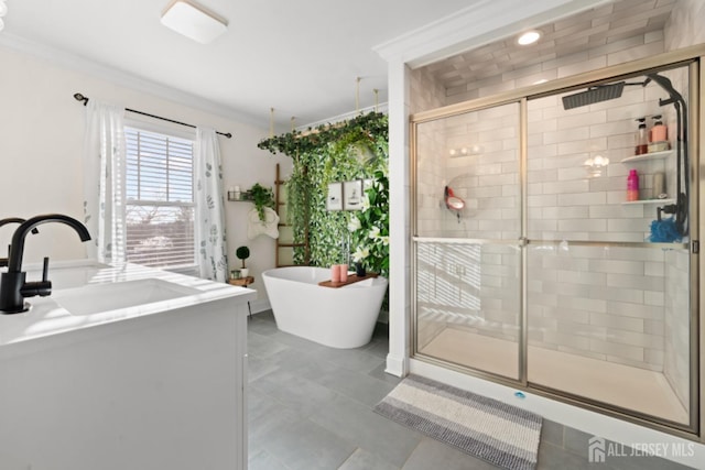 full bathroom featuring a shower stall, crown molding, a freestanding bath, and vanity