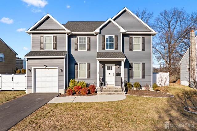 view of front of house featuring a garage and a front lawn