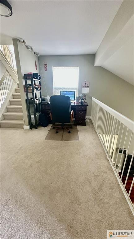 carpeted office with vaulted ceiling