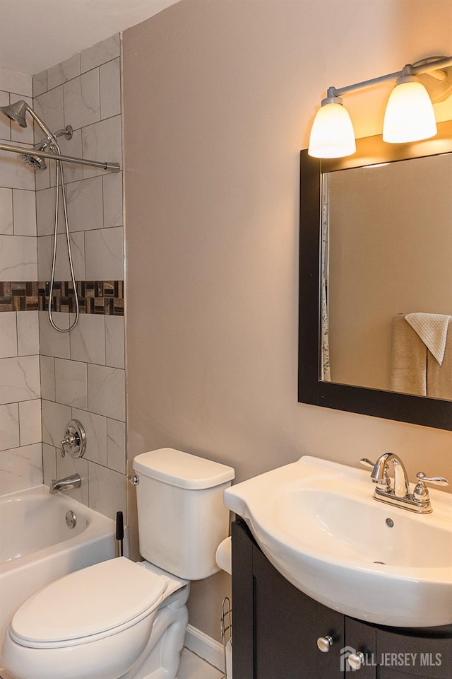 bathroom featuring toilet, shower / tub combination, vanity, and baseboards