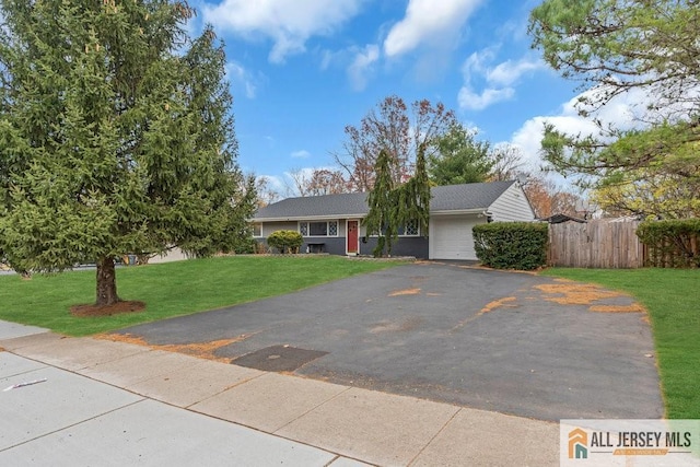 view of front of property with a front yard and a garage