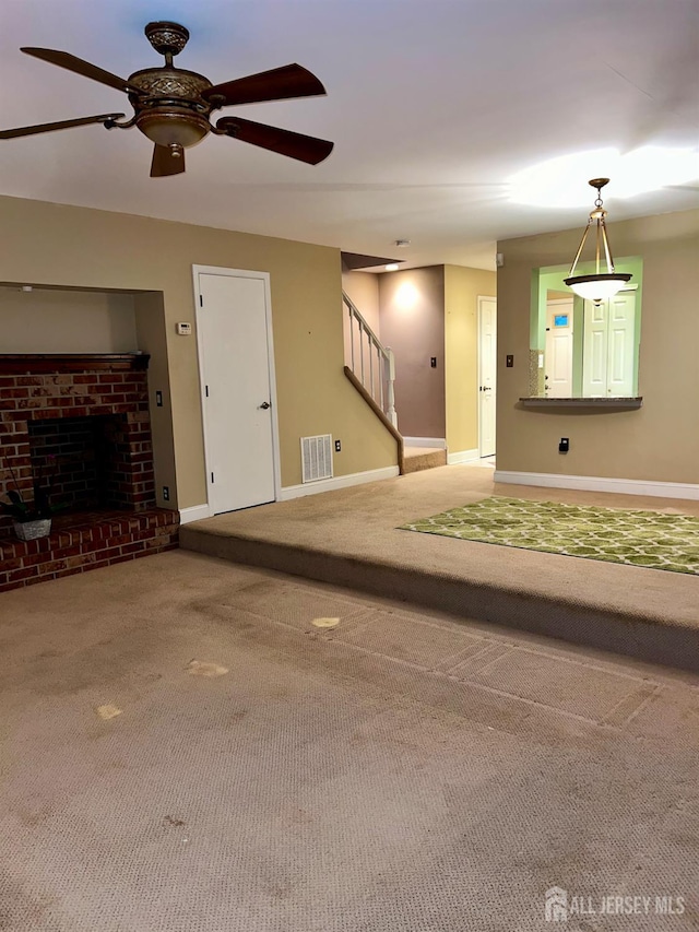 37 Albury Way N, Brunswick, NJ 08902 - unfurnished living room with carpet flooring, ceiling fan, stairway, and a brick fireplace