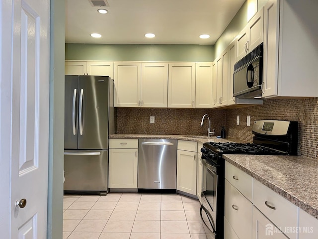 37 Albury Way N, Brunswick, NJ 08902 - kitchen with appliances with stainless steel finishes, light tile patterned flooring, tasteful backsplash, and recessed lighting