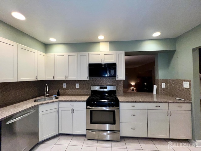 37 Albury Way N, Brunswick, NJ 08902 - kitchen featuring stainless steel appliances, tasteful backsplash, light tile patterned floors, white cabinetry, and recessed lighting